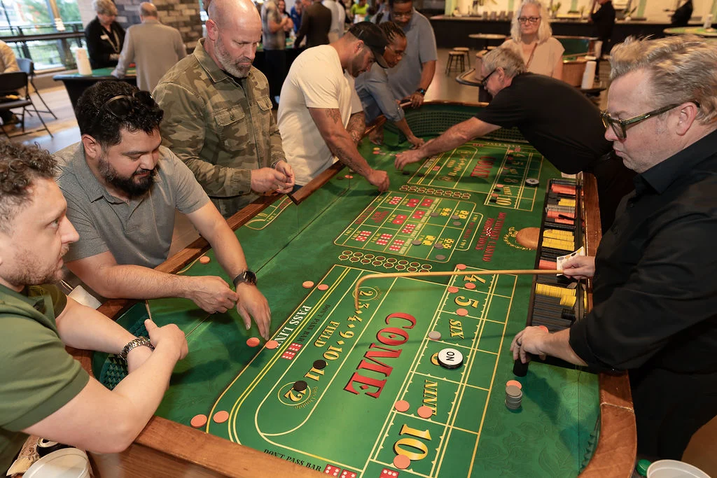 Attendees of Heroes by Day playing craps. 