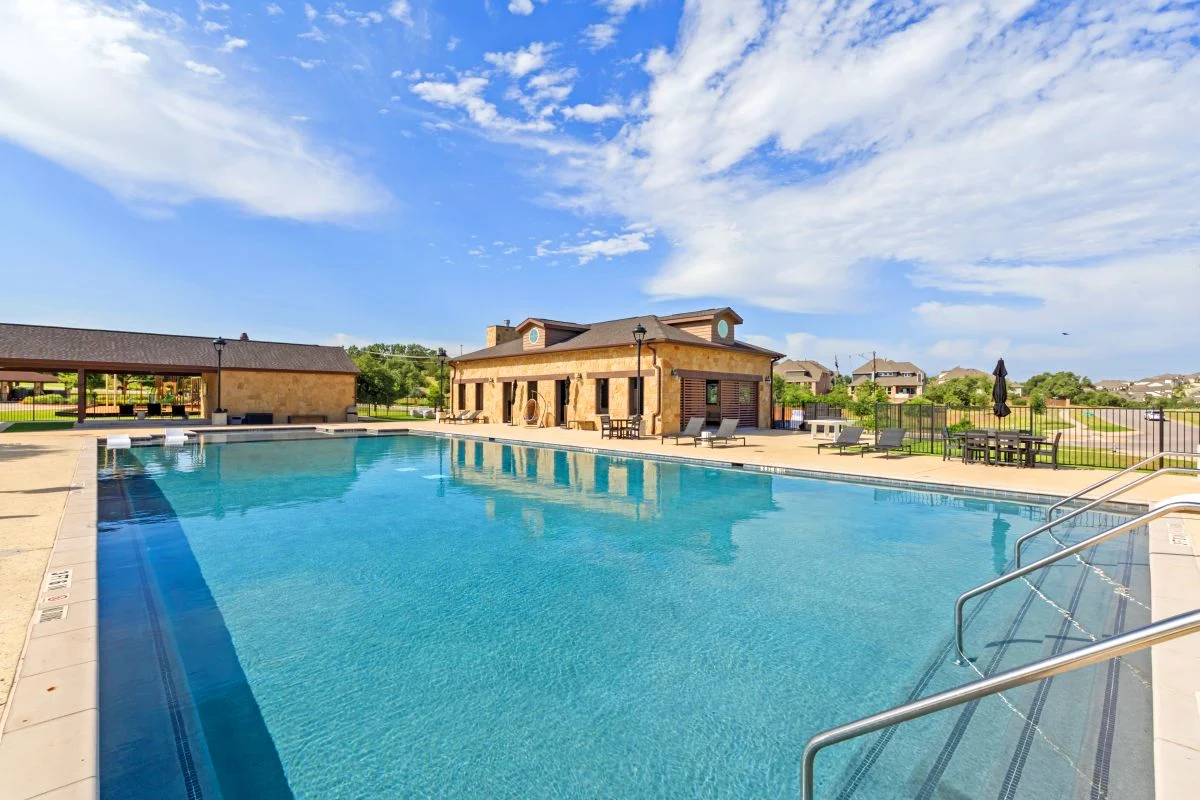 Provence's resort-style pool, with the pool house and pool-side seating in the background.