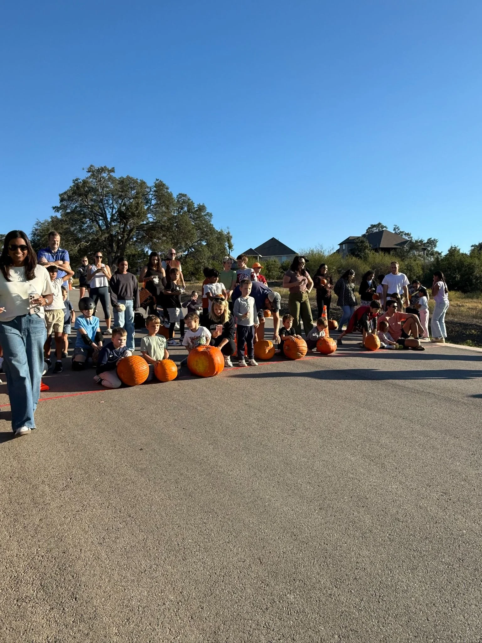Provence's Pumpkin Patch event featuring residents posing in front of their pumpkins. 